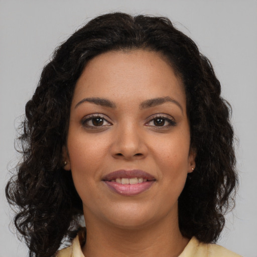 Joyful latino young-adult female with long  brown hair and brown eyes