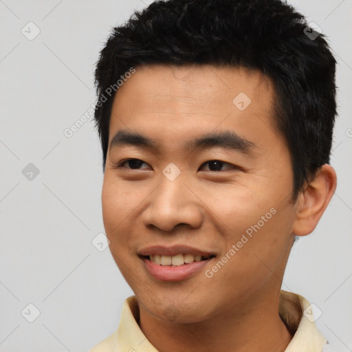 Joyful asian young-adult male with short  black hair and brown eyes