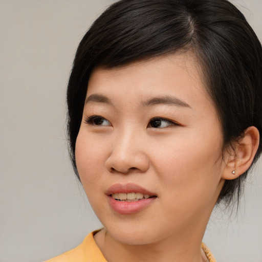 Joyful asian young-adult female with medium  brown hair and brown eyes