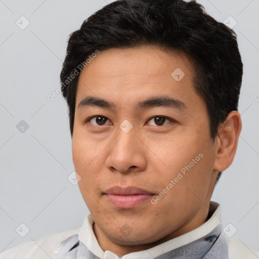 Joyful asian young-adult male with short  brown hair and brown eyes