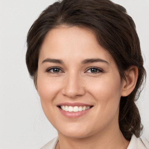 Joyful white young-adult female with medium  brown hair and brown eyes