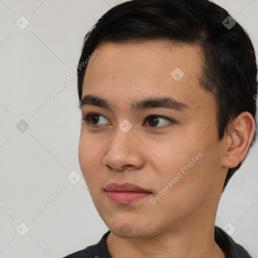 Joyful asian young-adult male with short  black hair and brown eyes