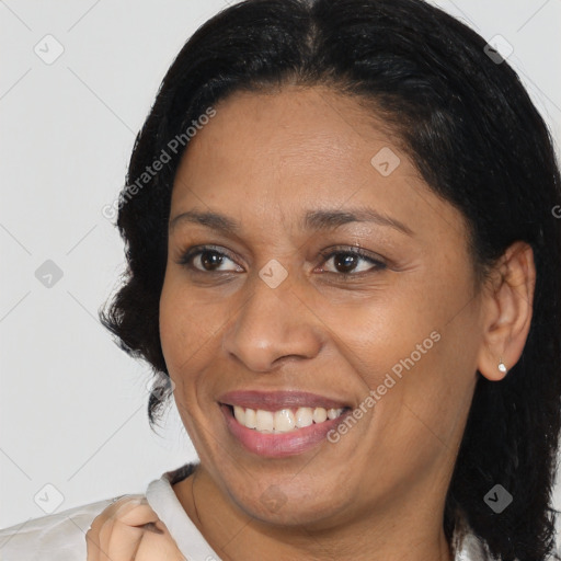 Joyful black adult female with medium  brown hair and brown eyes