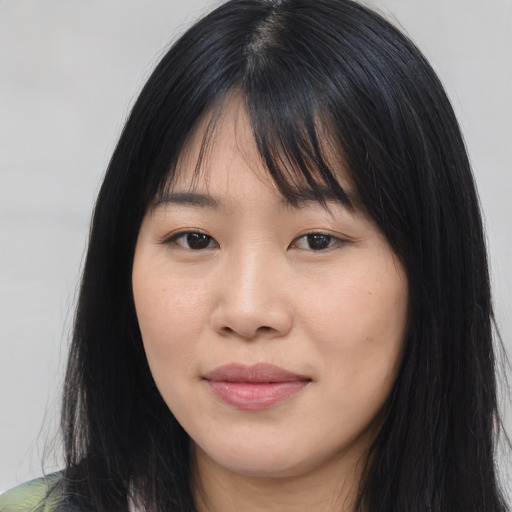 Joyful asian young-adult female with long  black hair and brown eyes