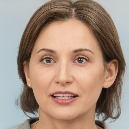 Joyful white adult female with medium  brown hair and brown eyes