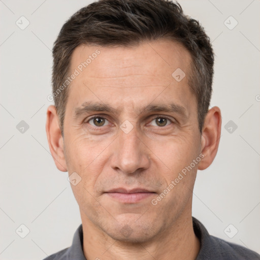 Joyful white adult male with short  brown hair and brown eyes