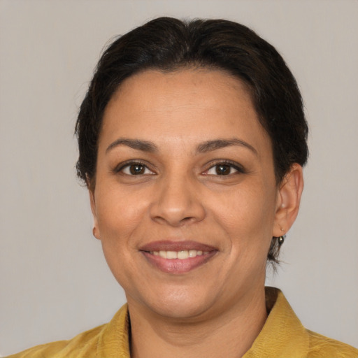 Joyful latino adult female with short  brown hair and brown eyes