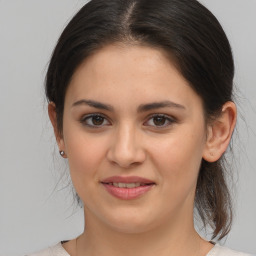 Joyful white young-adult female with medium  brown hair and brown eyes