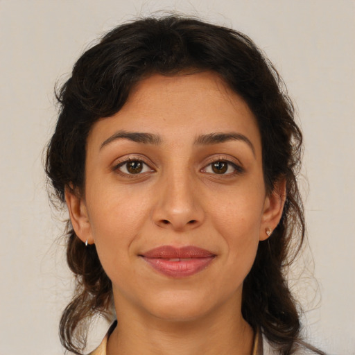 Joyful latino young-adult female with medium  brown hair and brown eyes