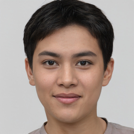 Joyful asian young-adult male with short  brown hair and brown eyes