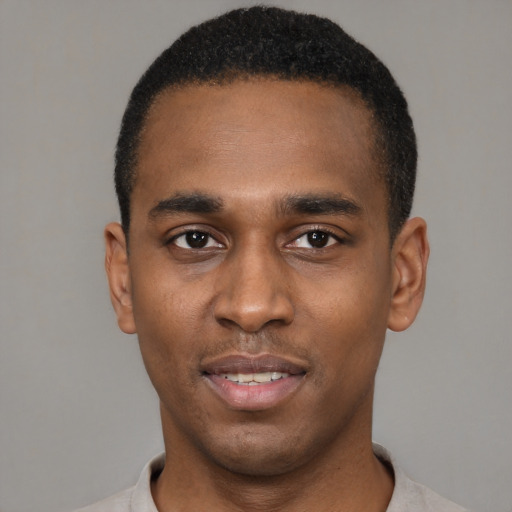 Joyful black young-adult male with short  black hair and brown eyes