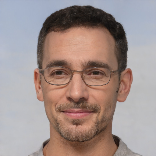 Joyful white adult male with short  brown hair and brown eyes