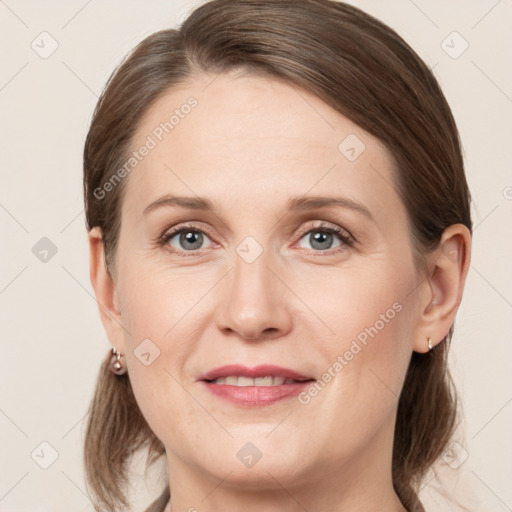 Joyful white adult female with medium  brown hair and grey eyes