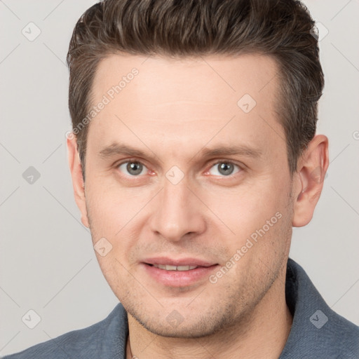 Joyful white adult male with short  brown hair and brown eyes