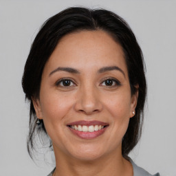 Joyful white adult female with medium  brown hair and brown eyes