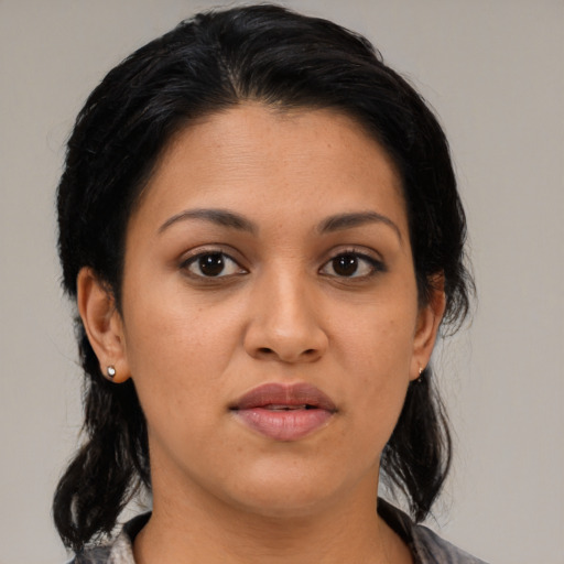 Joyful latino young-adult female with medium  black hair and brown eyes