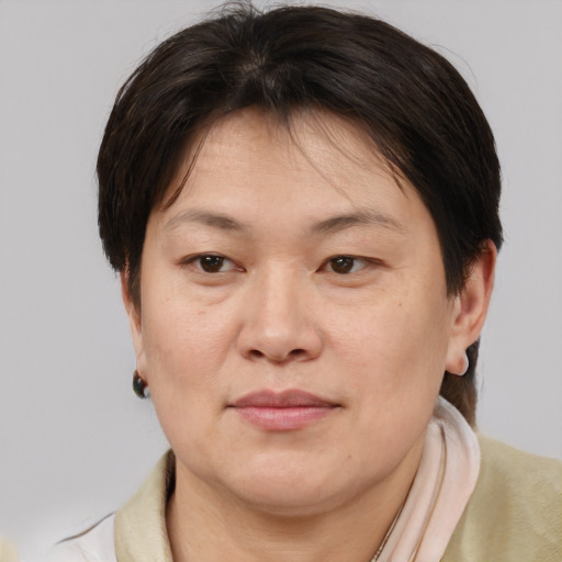 Joyful asian adult female with medium  brown hair and brown eyes