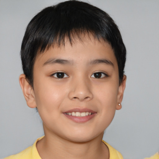 Joyful asian child male with short  brown hair and brown eyes