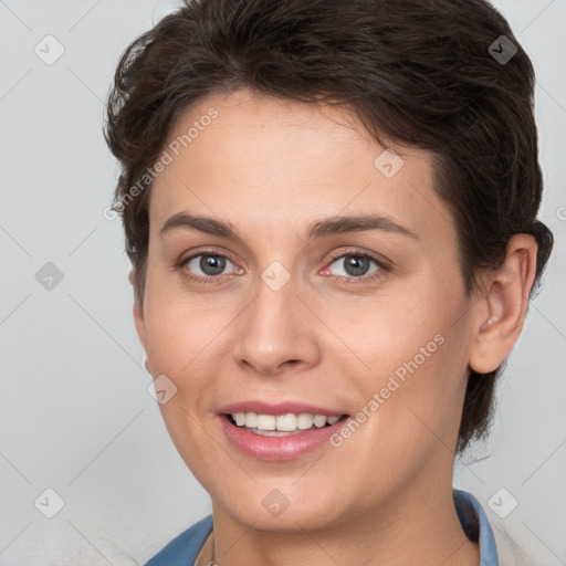 Joyful white young-adult female with short  brown hair and brown eyes