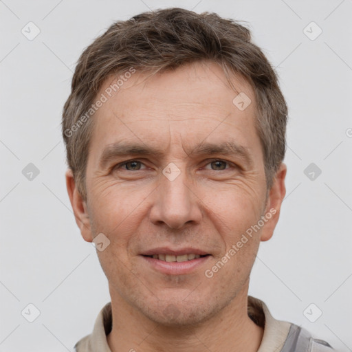 Joyful white adult male with short  brown hair and grey eyes