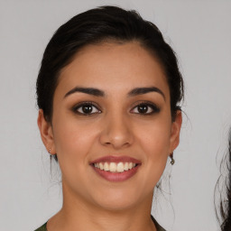 Joyful latino young-adult female with medium  brown hair and brown eyes