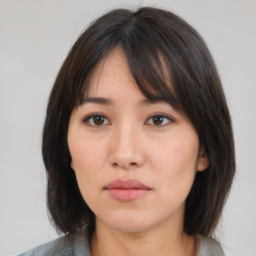 Neutral asian young-adult female with medium  brown hair and brown eyes