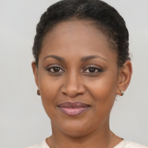 Joyful black young-adult female with short  brown hair and brown eyes