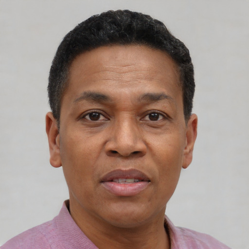 Joyful black adult male with short  black hair and brown eyes