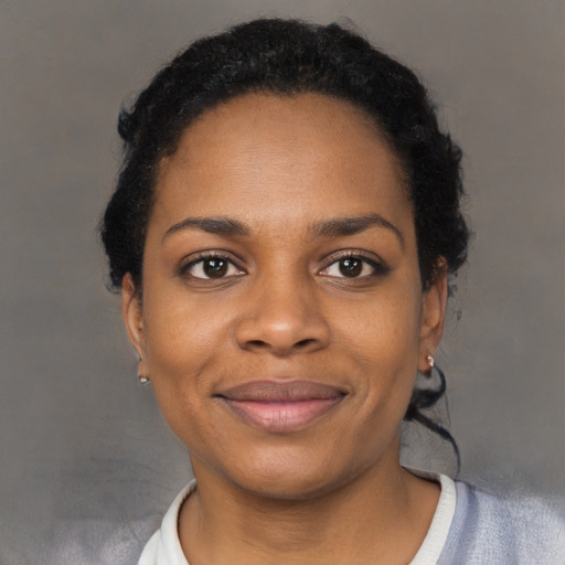 Joyful black young-adult female with short  brown hair and brown eyes