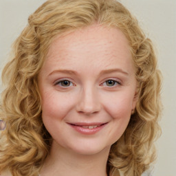 Joyful white young-adult female with medium  brown hair and blue eyes