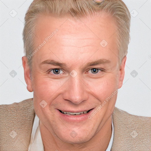 Joyful white adult male with short  brown hair and blue eyes