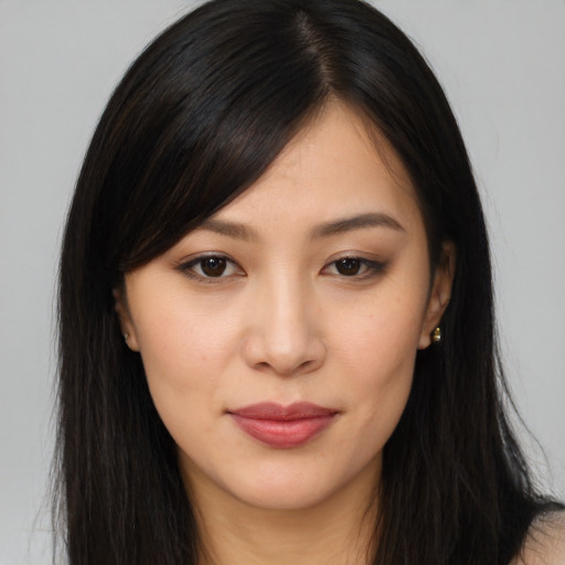 Joyful asian young-adult female with long  brown hair and brown eyes