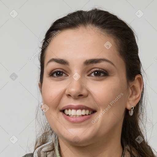 Joyful white young-adult female with medium  brown hair and grey eyes