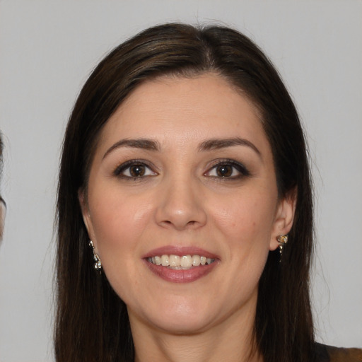 Joyful white young-adult female with long  brown hair and brown eyes