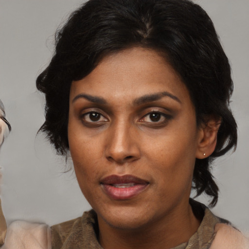 Joyful asian adult female with medium  black hair and brown eyes