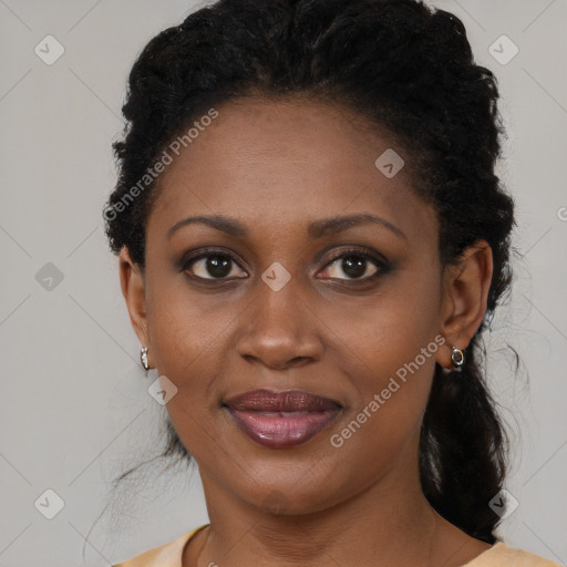 Joyful black young-adult female with long  black hair and brown eyes