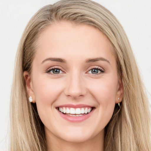 Joyful white young-adult female with long  brown hair and blue eyes