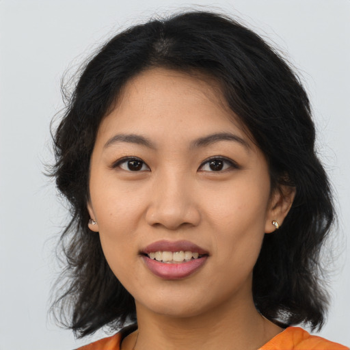 Joyful asian young-adult female with medium  brown hair and brown eyes