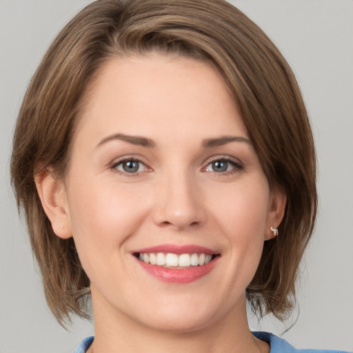 Joyful white young-adult female with medium  brown hair and grey eyes