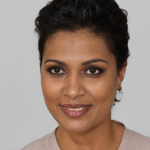 Joyful black young-adult female with short  brown hair and brown eyes