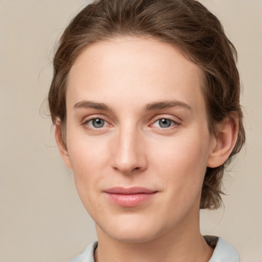 Joyful white young-adult female with medium  brown hair and green eyes