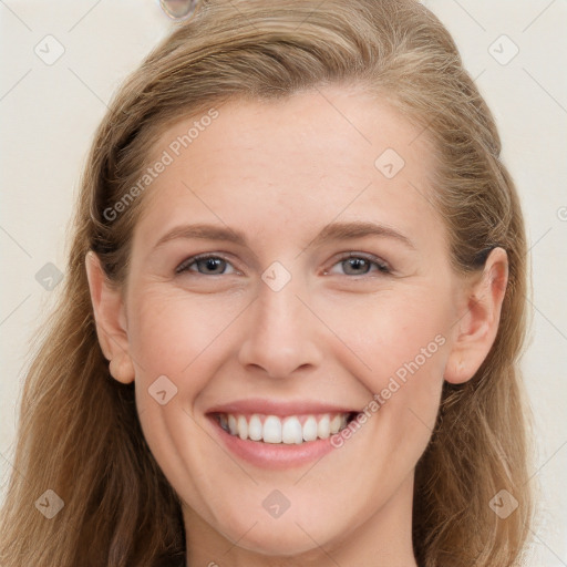 Joyful white young-adult female with long  brown hair and blue eyes