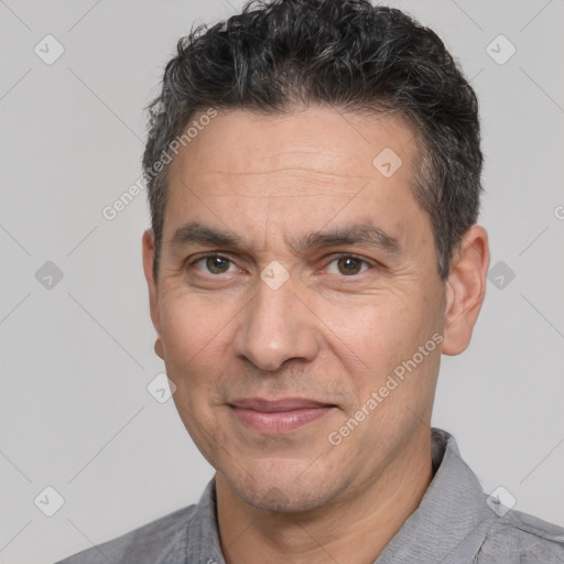 Joyful white adult male with short  black hair and brown eyes