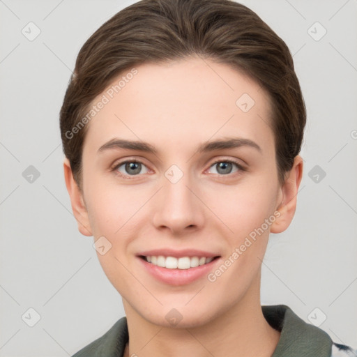 Joyful white young-adult female with short  brown hair and grey eyes