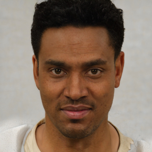 Joyful black young-adult male with short  black hair and brown eyes