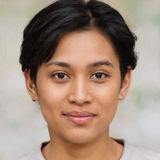 Joyful latino young-adult female with short  brown hair and brown eyes