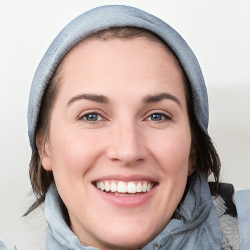 Joyful white young-adult female with medium  brown hair and blue eyes