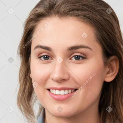 Joyful white young-adult female with long  brown hair and grey eyes