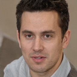 Joyful white adult male with short  brown hair and brown eyes