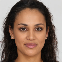 Joyful latino young-adult female with long  brown hair and brown eyes
